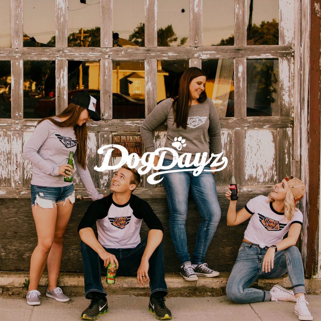 DogDayz logo over a photo of five friends in branded apparel by a weathered garage door