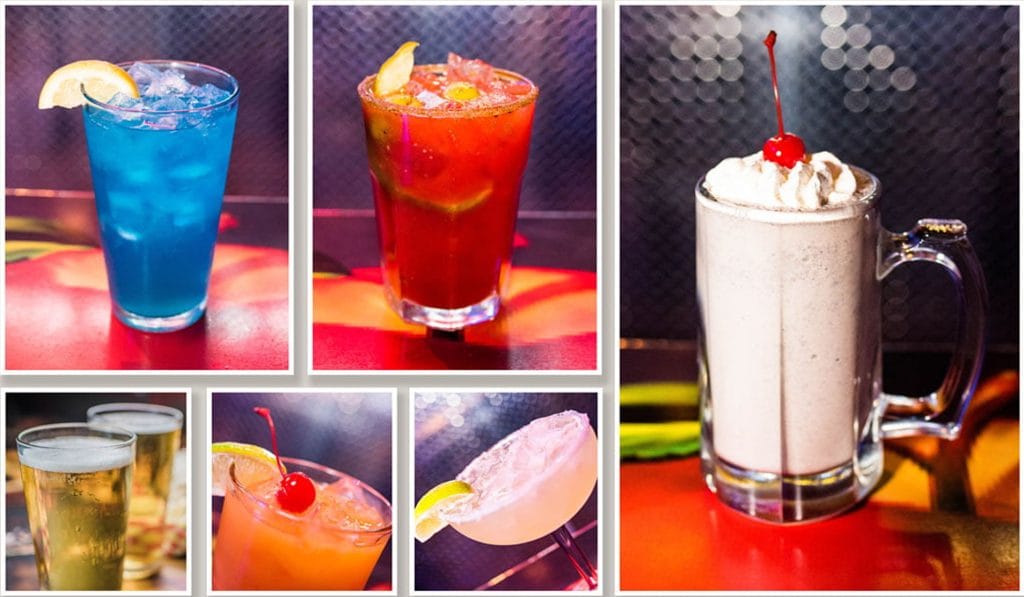 Bar drink photography: cocktails, beer and a cherry-topped milkshake under coloured light