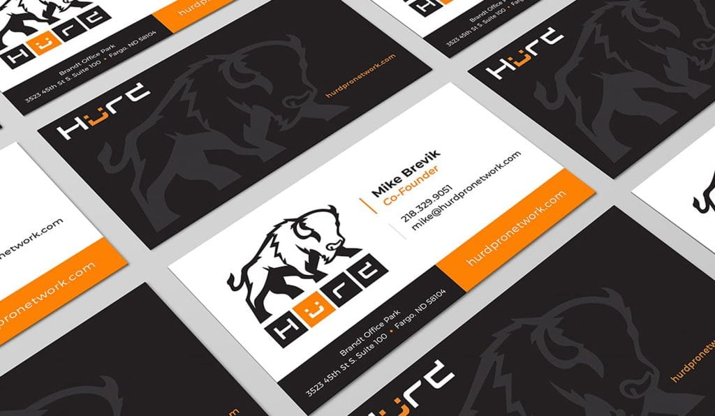 Hurd Pro Network business cards with a charging bison logo in black, white and orange