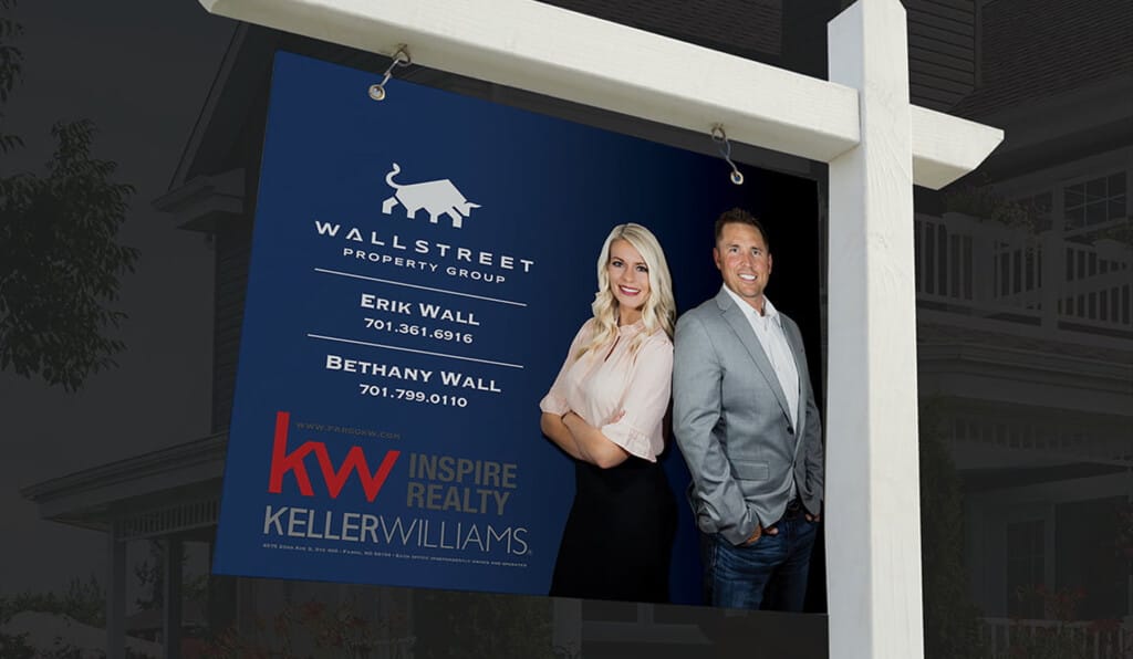Wallstreet Property Group real estate yard sign with agents Erik and Bethany Wall and Keller Williams branding